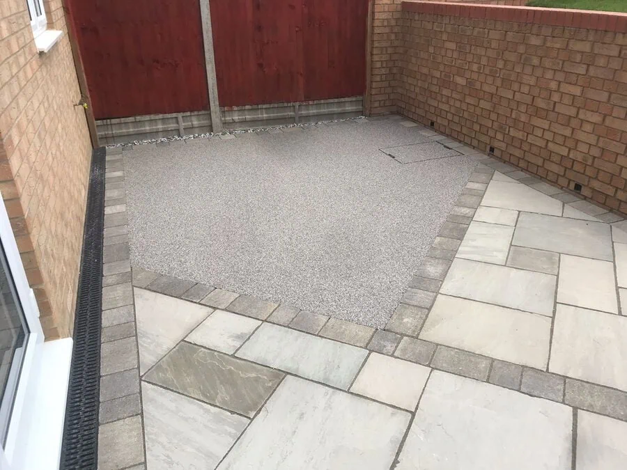 A courtyard in silver resin with a sandstone surround