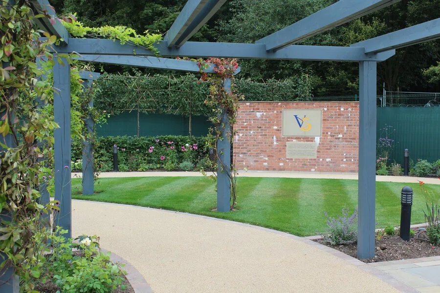 Resin walkway beneath a pergola
