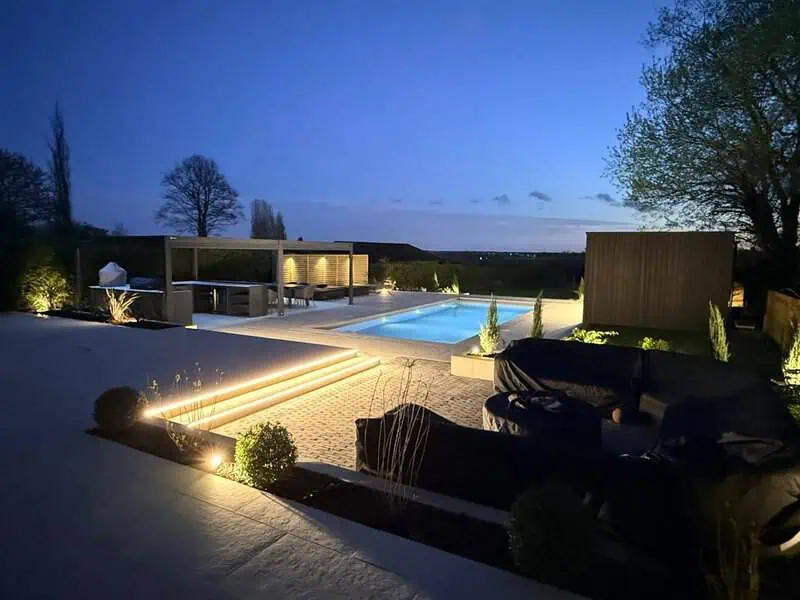 Lit garden steps, outdoor seating and poolside relaxation area
