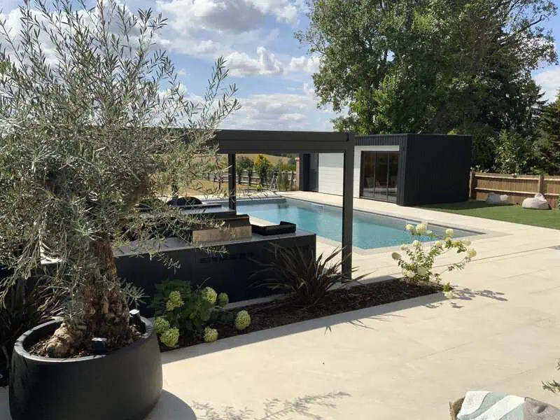 Contemporary spa and pool garden with paved terrace and pergola