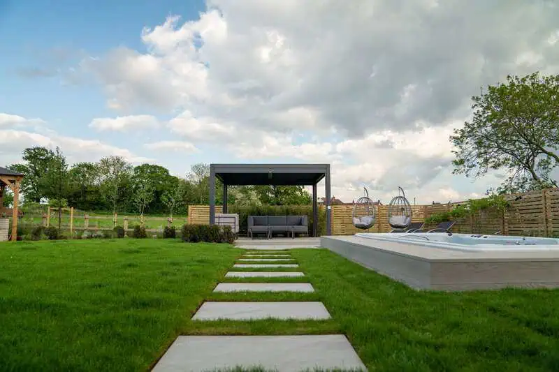 Stepping-stone walkway leading through a luxury pool and spa garden