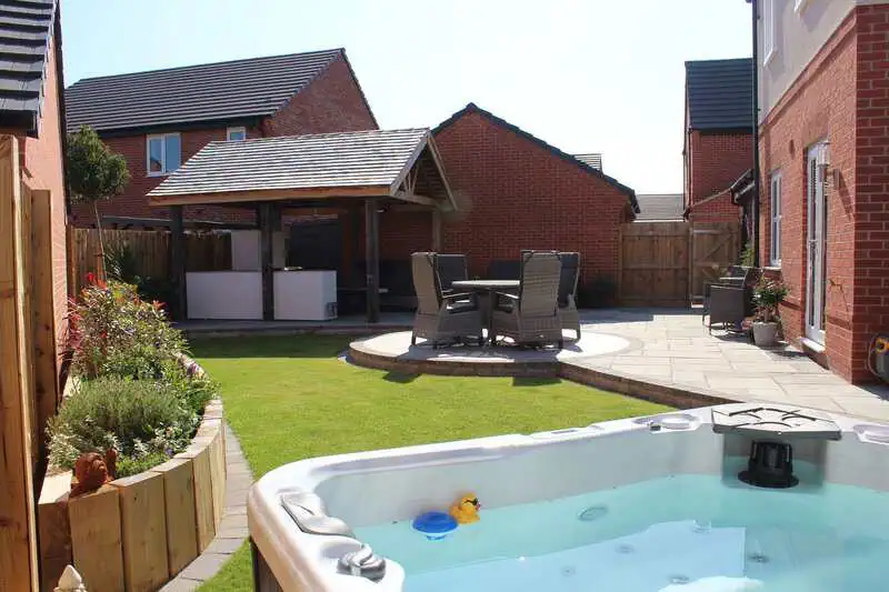Spa terrace with lawn, paving and relaxed outdoor seating
